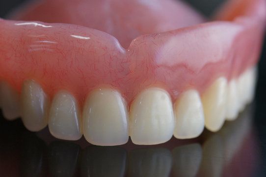 A full-arch denture sitting on a table